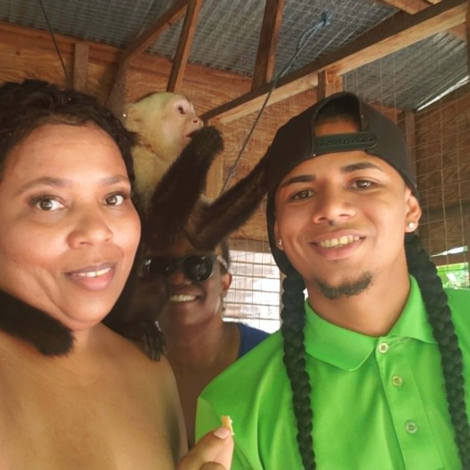 Group posing with a capuchin monkey